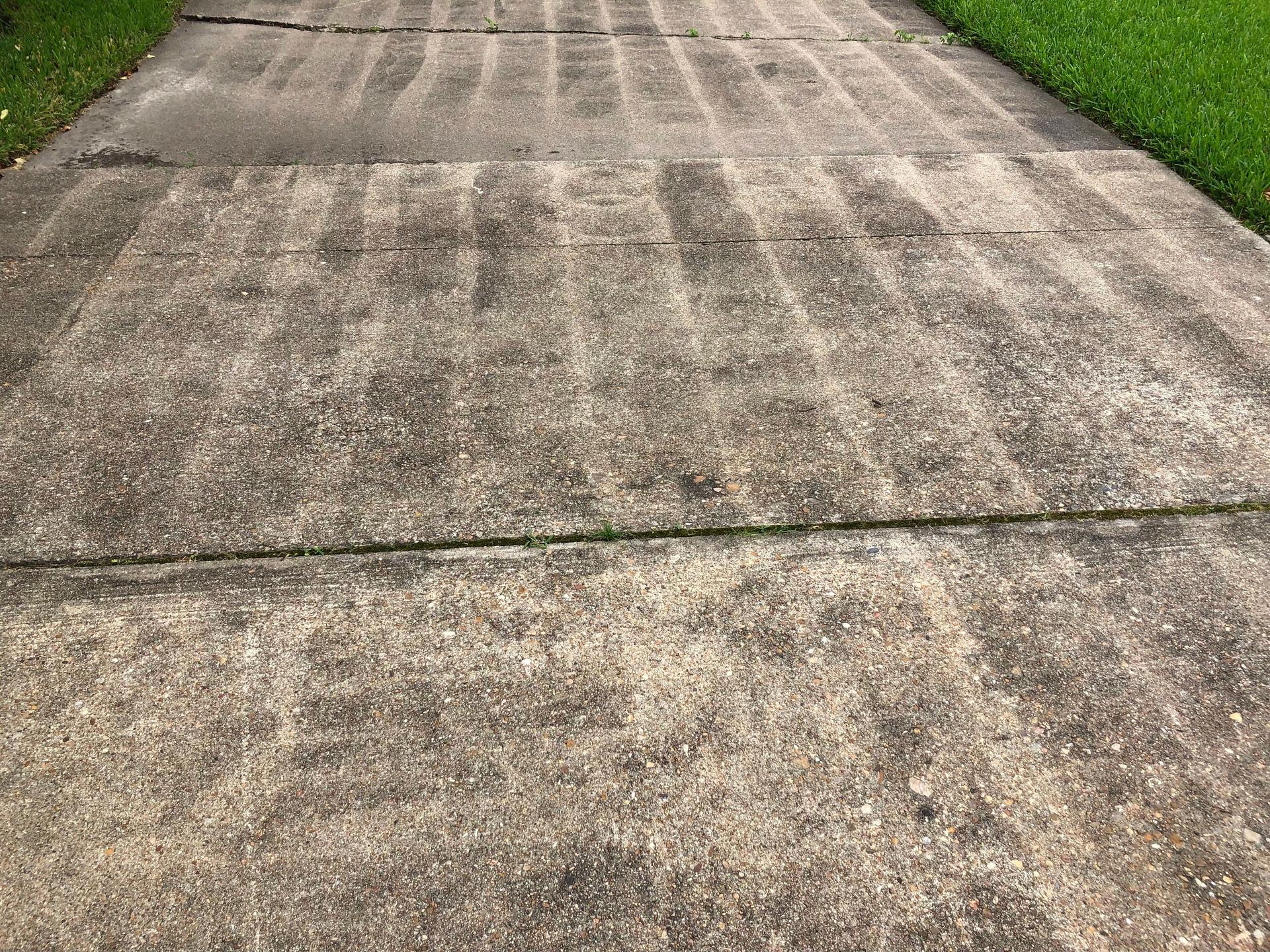 Striped pattern on driveway from a poor power washing job